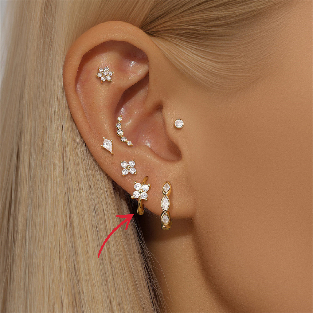14K gold CZ clover hoop earrings paired with other sparkling jewelry, creating a chic and trendy look