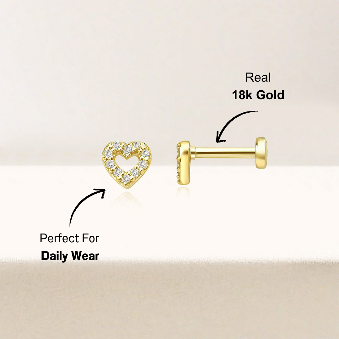 Close-up shot of 14k gold-plated heart-shaped zirconia stud earrings with sparkling stones, a classic accessory for any occasion.
