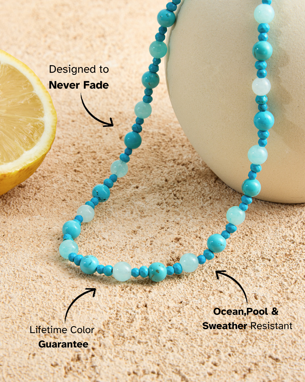 Turquoise beaded necklace on sand with lemon and white container, highlighting durability and colorfastness.