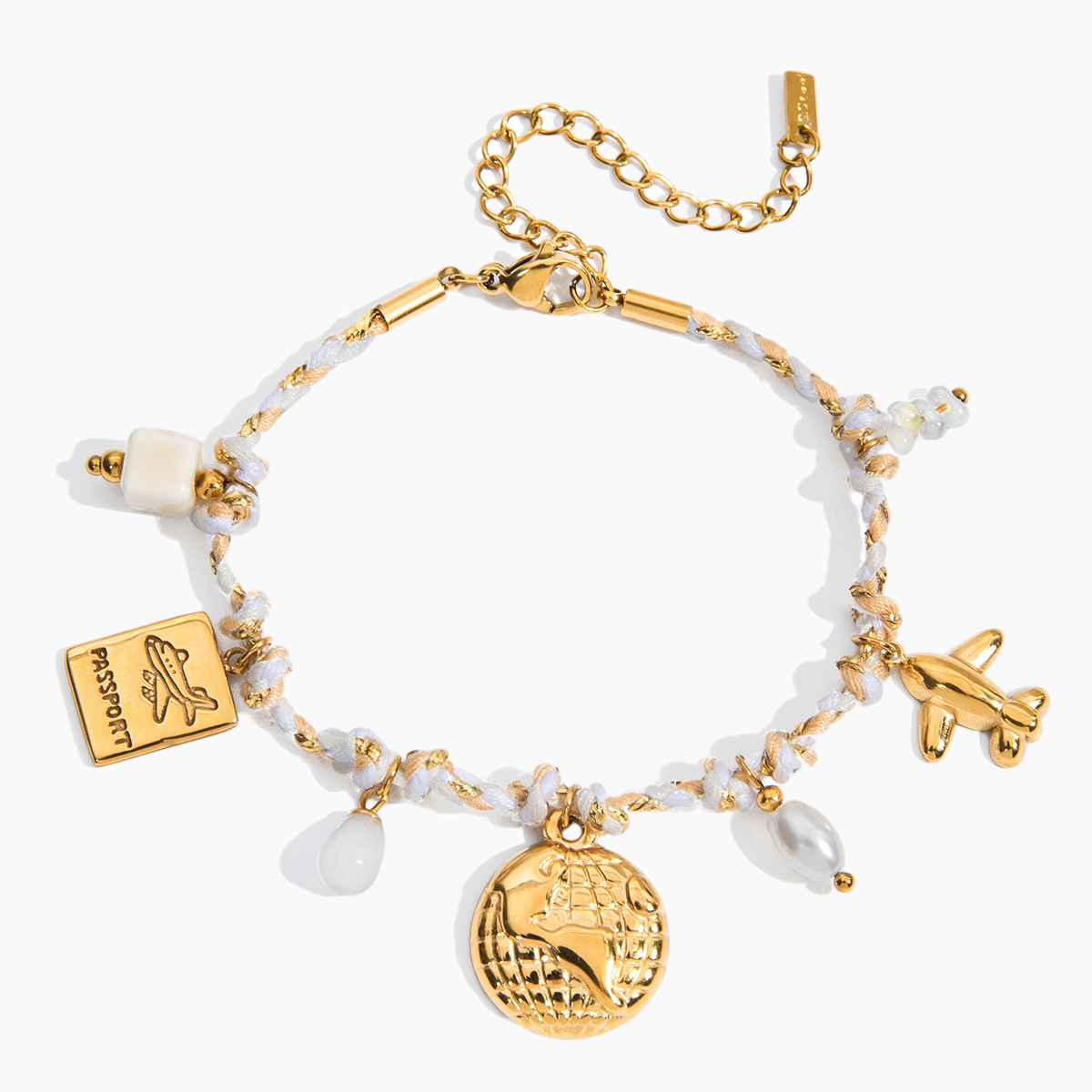 Gold and white beaded bracelet with charms on a white background