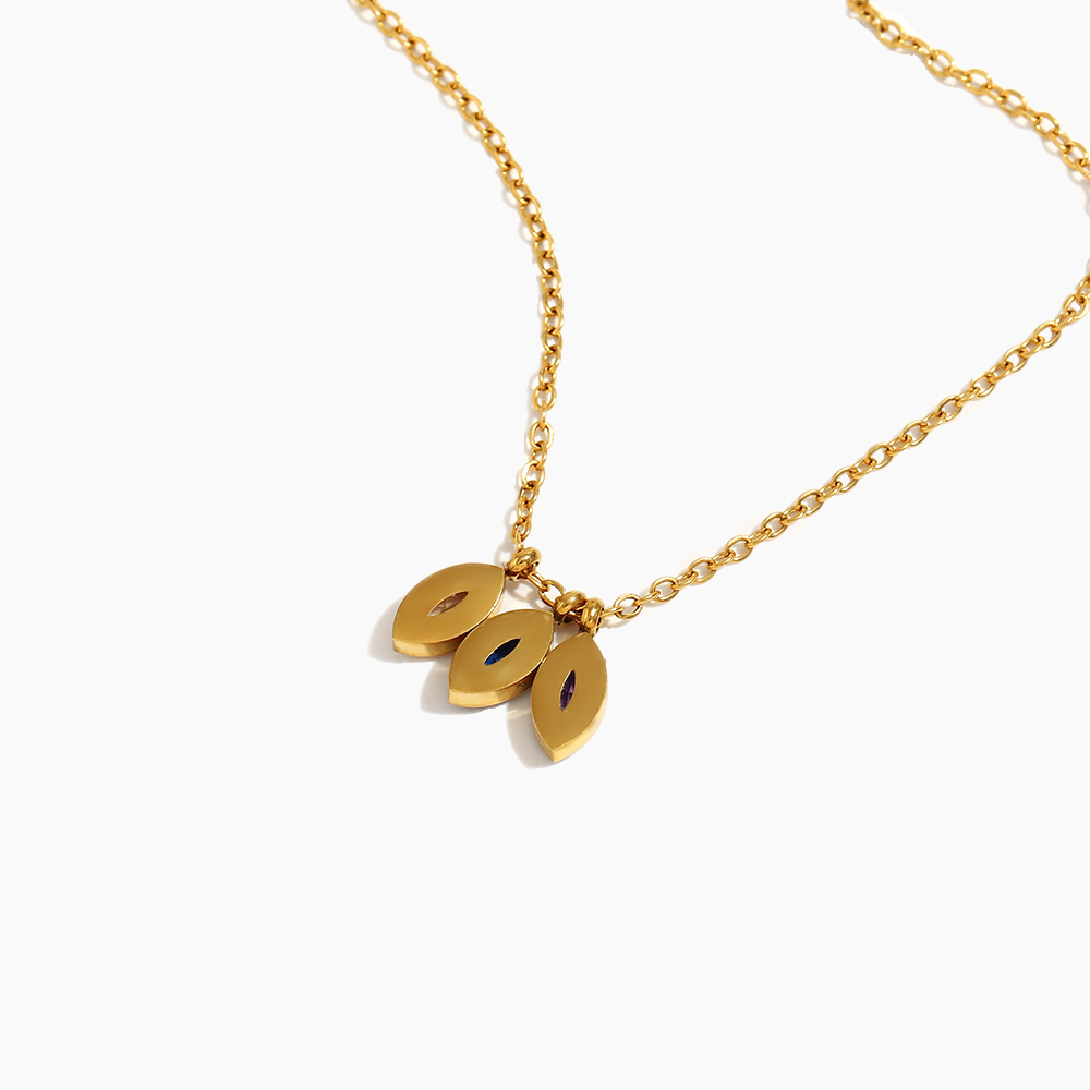 Gold necklace with three oval pendants on a white background