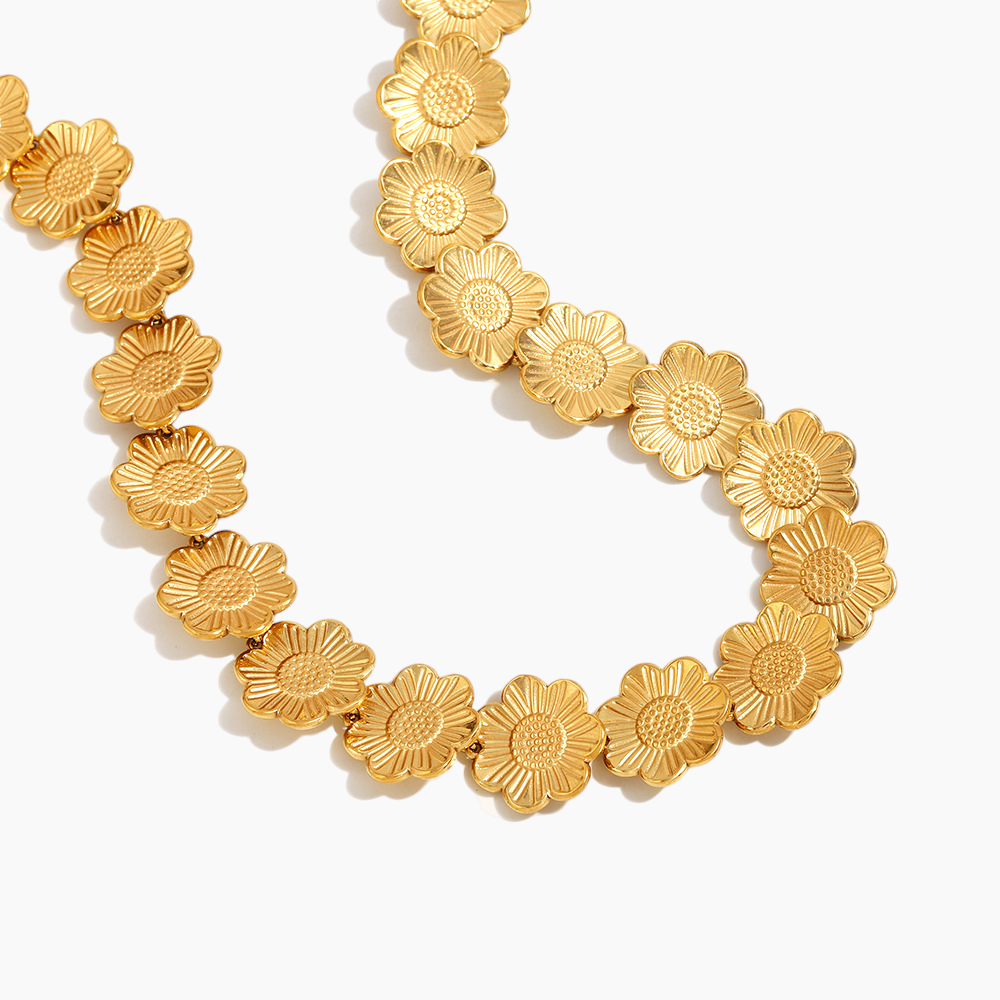 Gold floral necklace on a white background