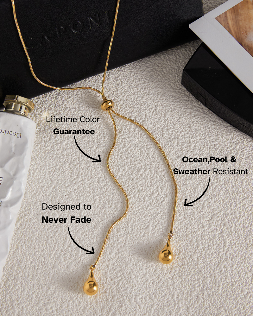 Gold necklace with text highlighting features on a textured surface