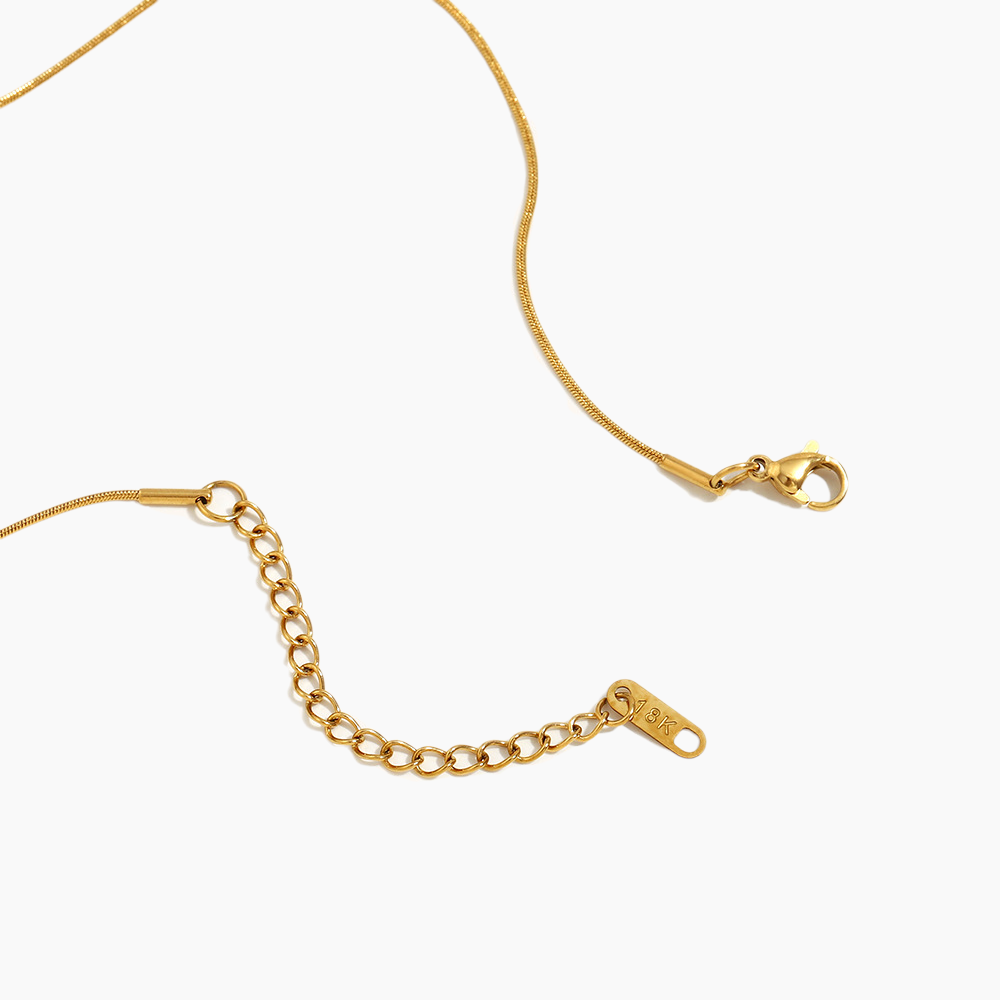 Gold chain necklace on a white background