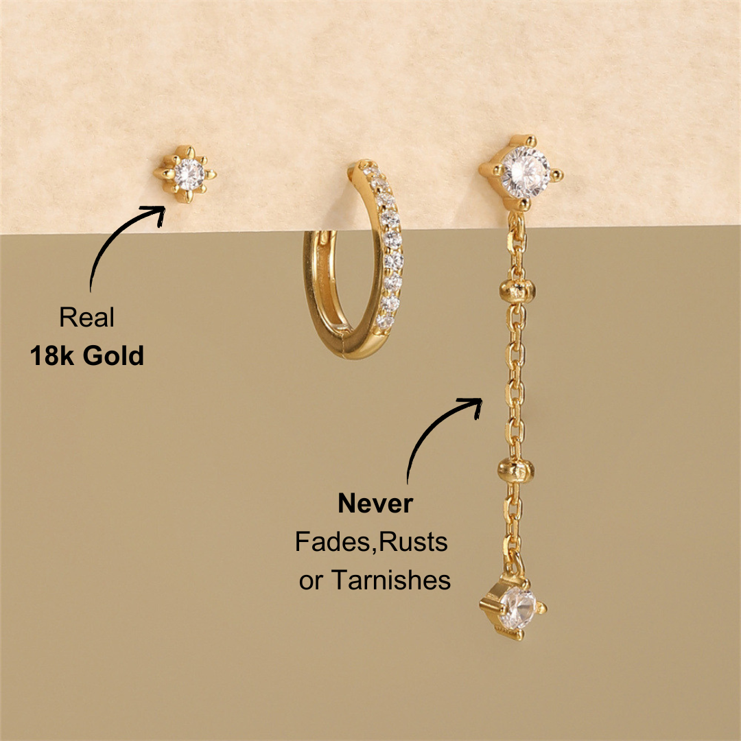 Styled shot of a 3-piece 925 sterling silver jewelry set with zirconia stones, featuring a stud earring, hoop earring, and dangling earring, displayed against a neutral background.