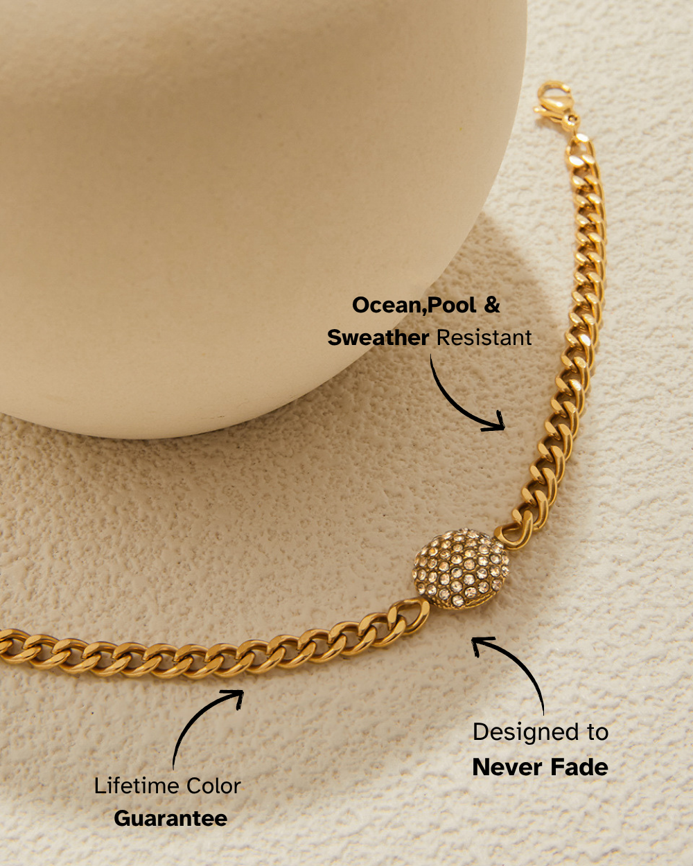 Gold chain bracelet with text highlighting features on a beige background