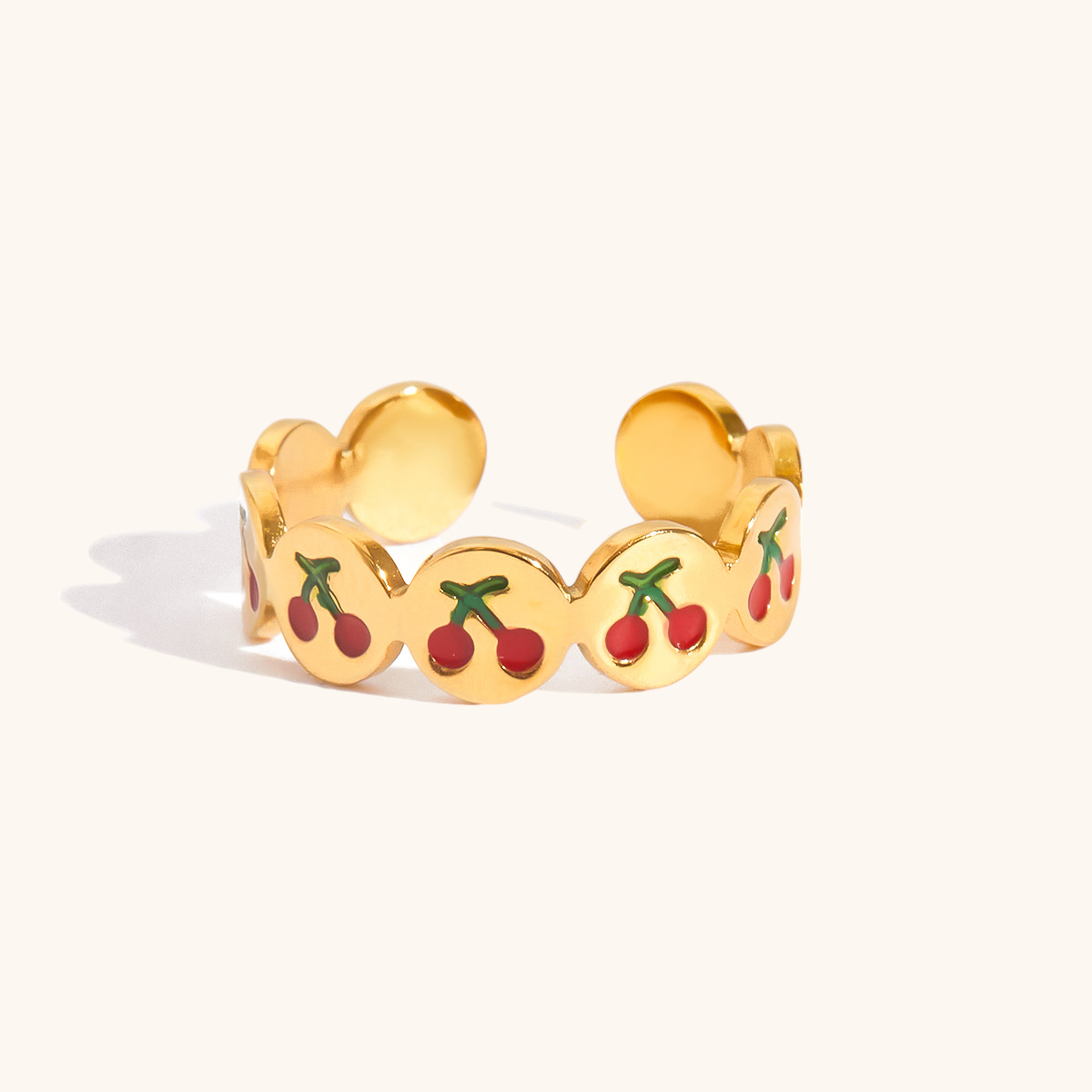 Open-style cherry rings with vibrant red and green enamel details