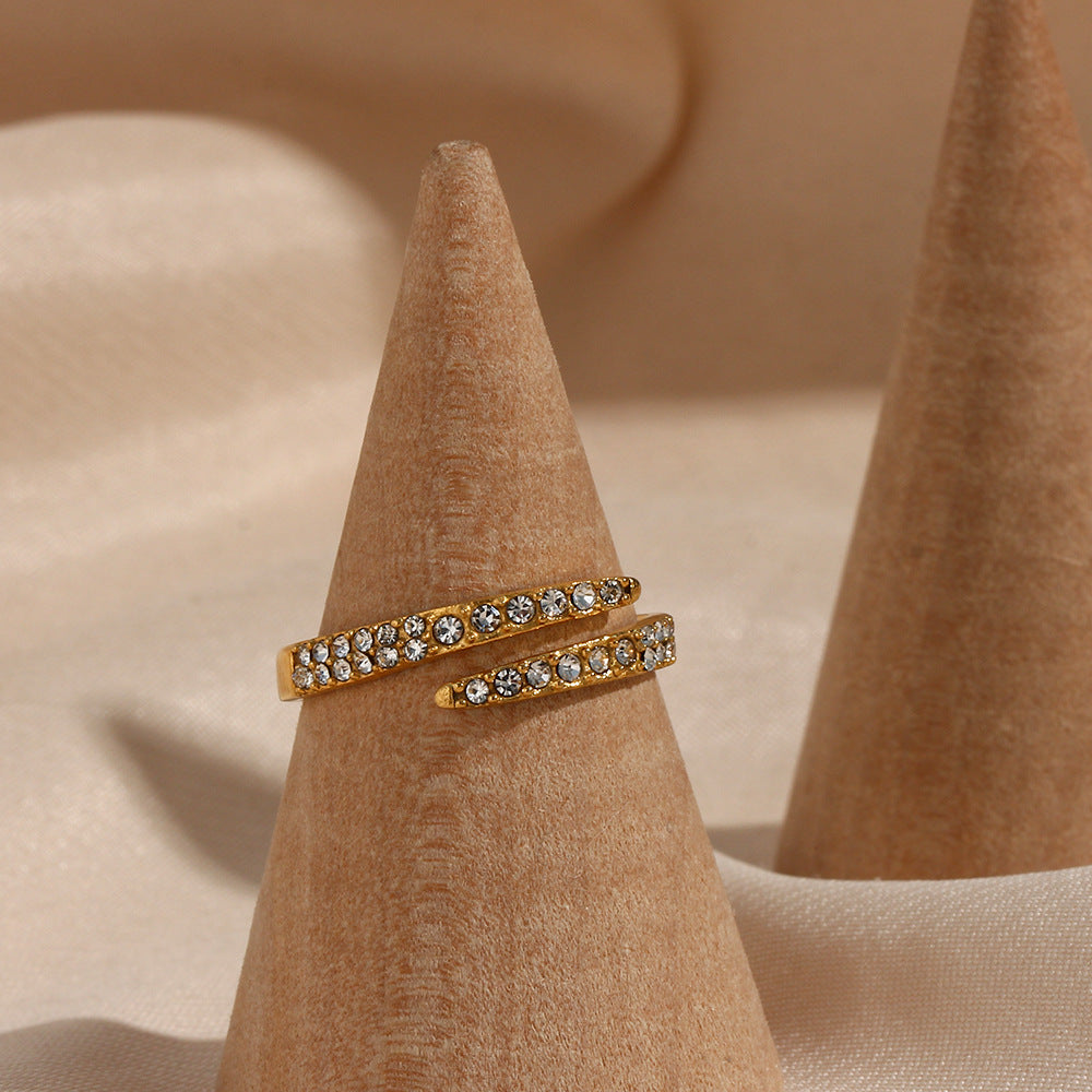 Minimalist gold ring with two rows of rhinestones on velvet background