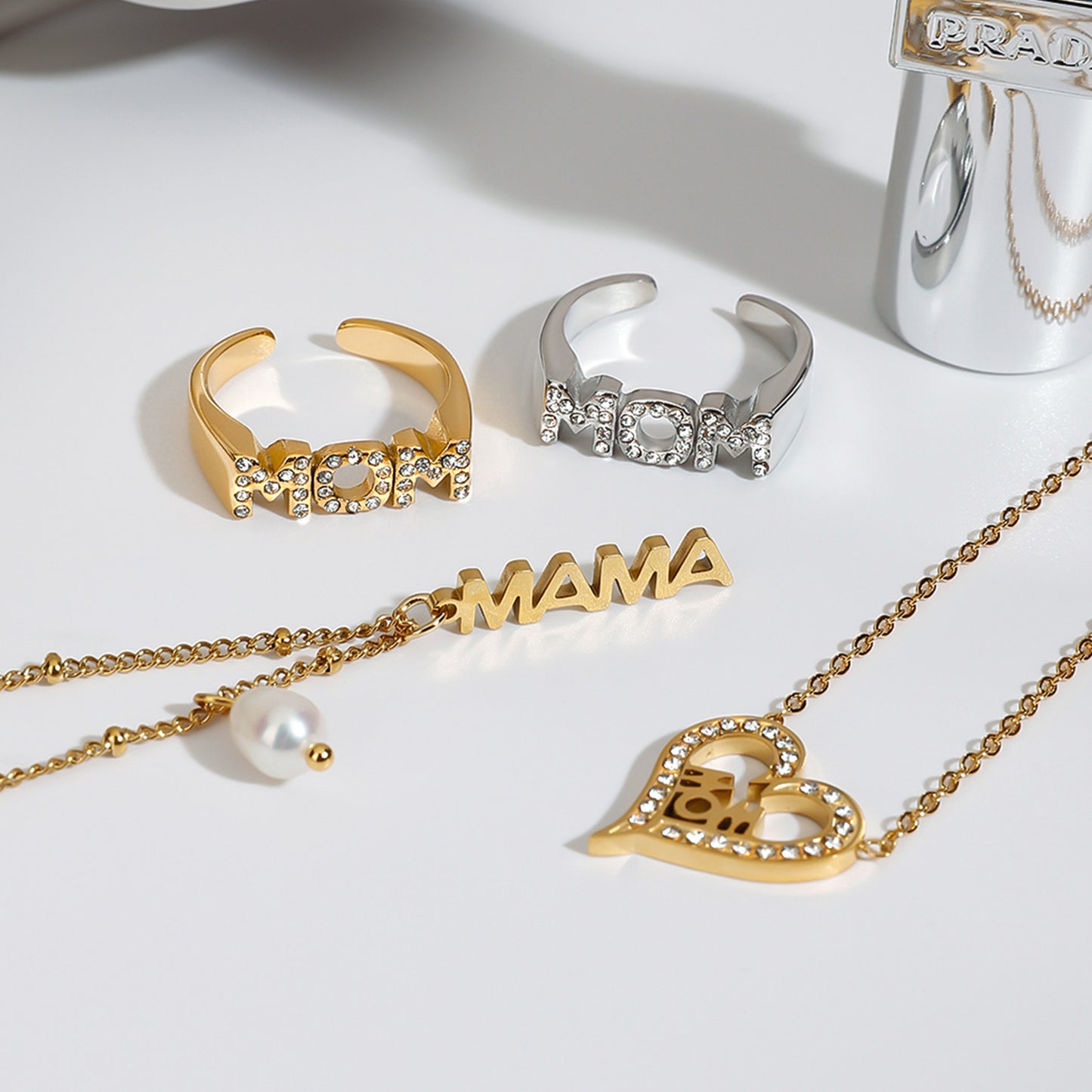 Full view of gold necklace with adjustable chain and dangling MAMA charm and pearl