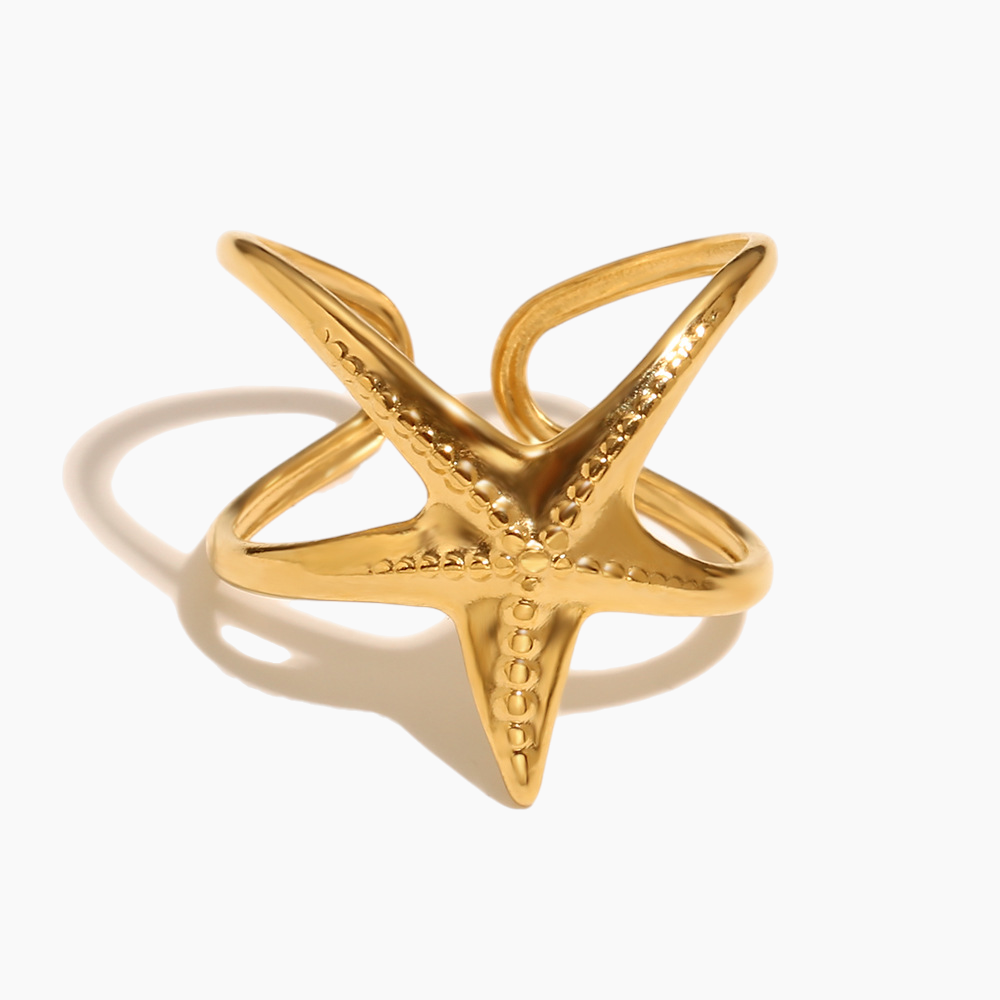 Elegant gold starfish statement ring shining in natural sunlight