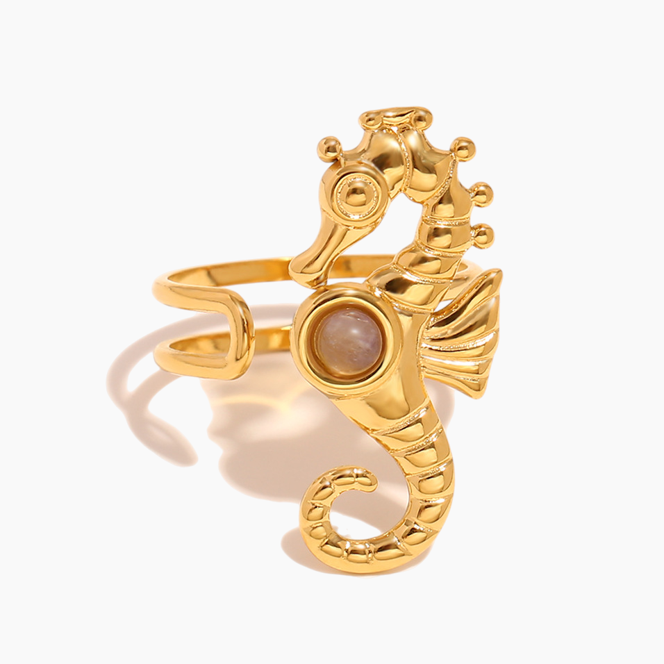 Seahorse serenity ring paired with layered ocean-inspired jewelry