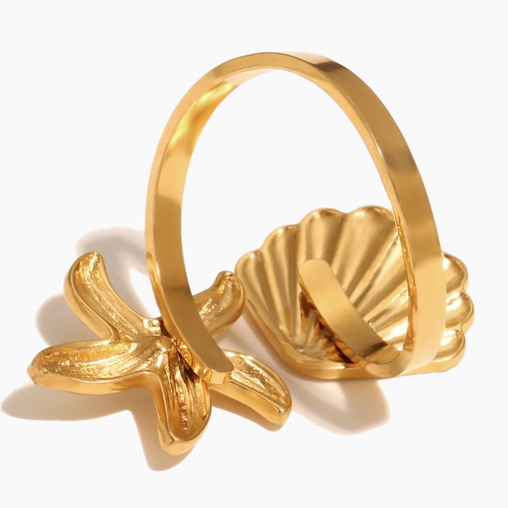 Ocean inspired starfish seashell ring paired with layered jewelry