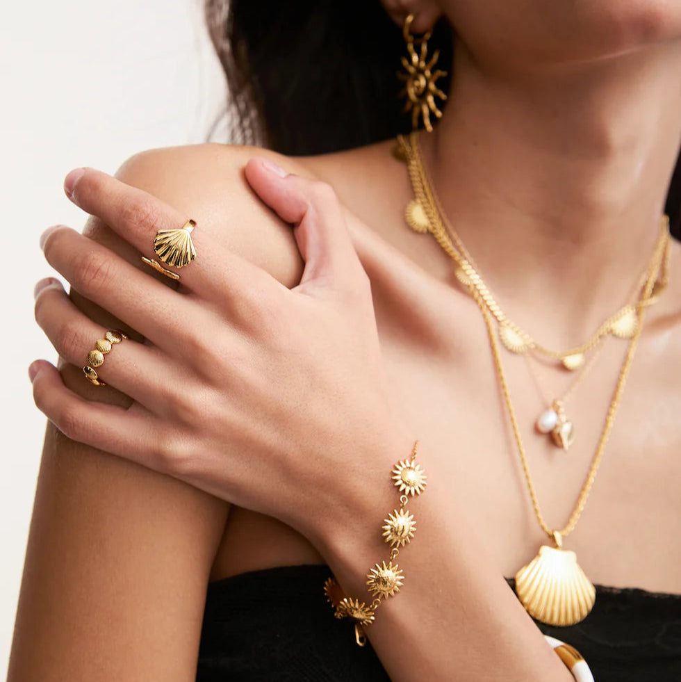 Adjustable gold seaside ring sparkling in natural sunlight