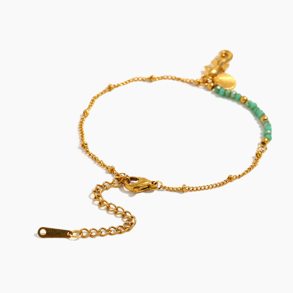 Seaside serenity bracelet styled flat on sand-tone background with seashell accents