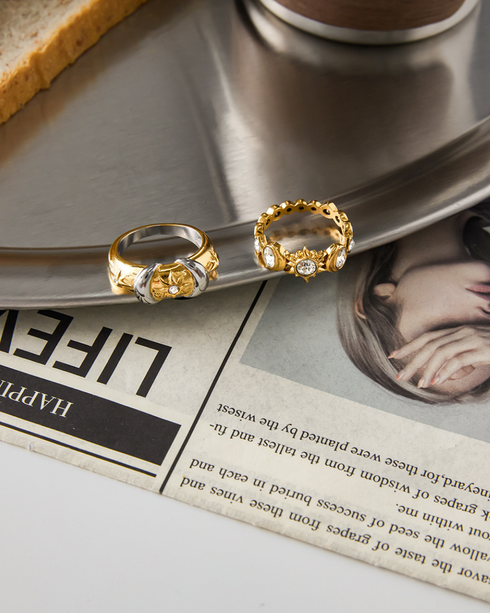Two gold rings on a newspaper with a blurred background