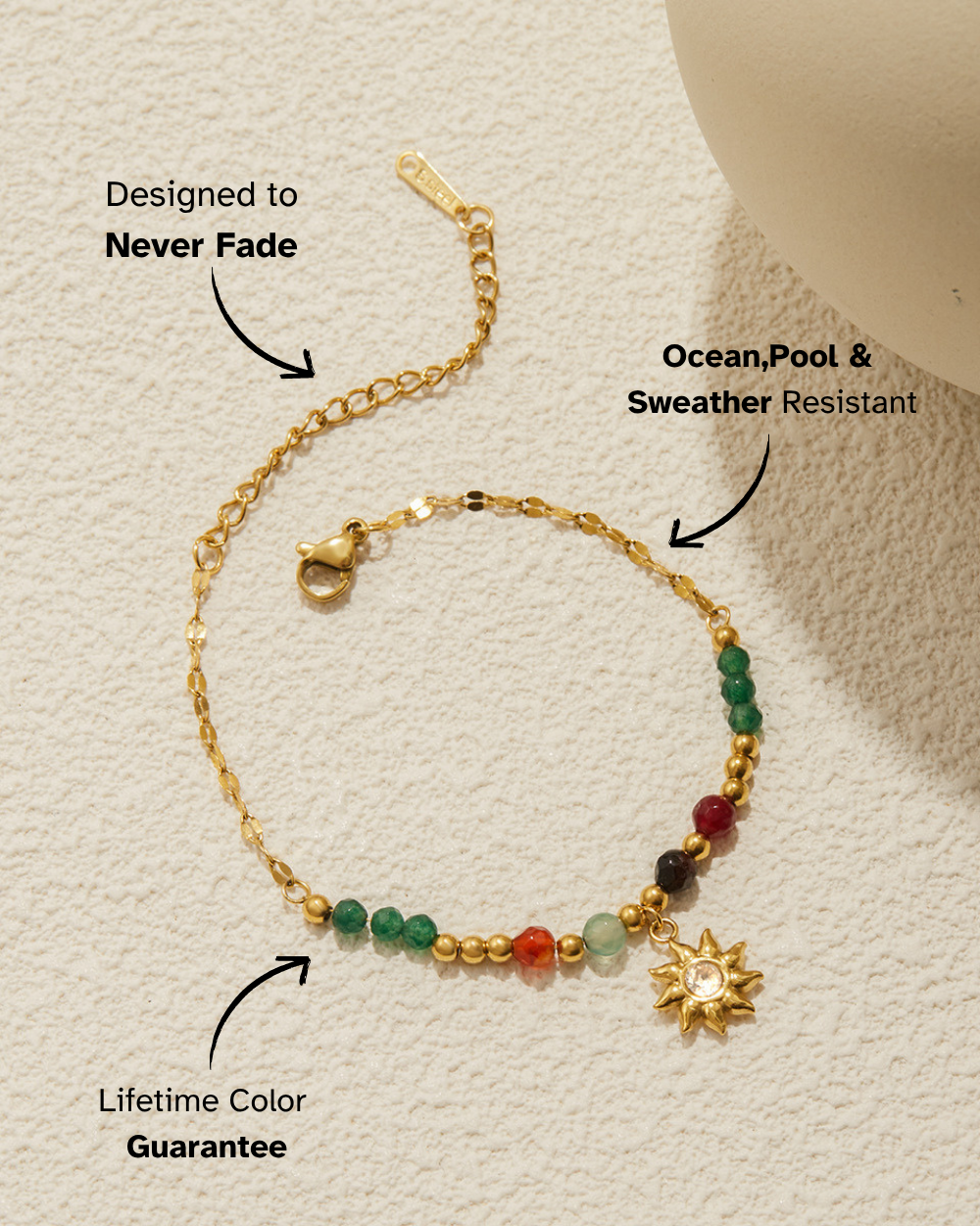 Gold bracelet with colored beads and a sun charm on a beige background