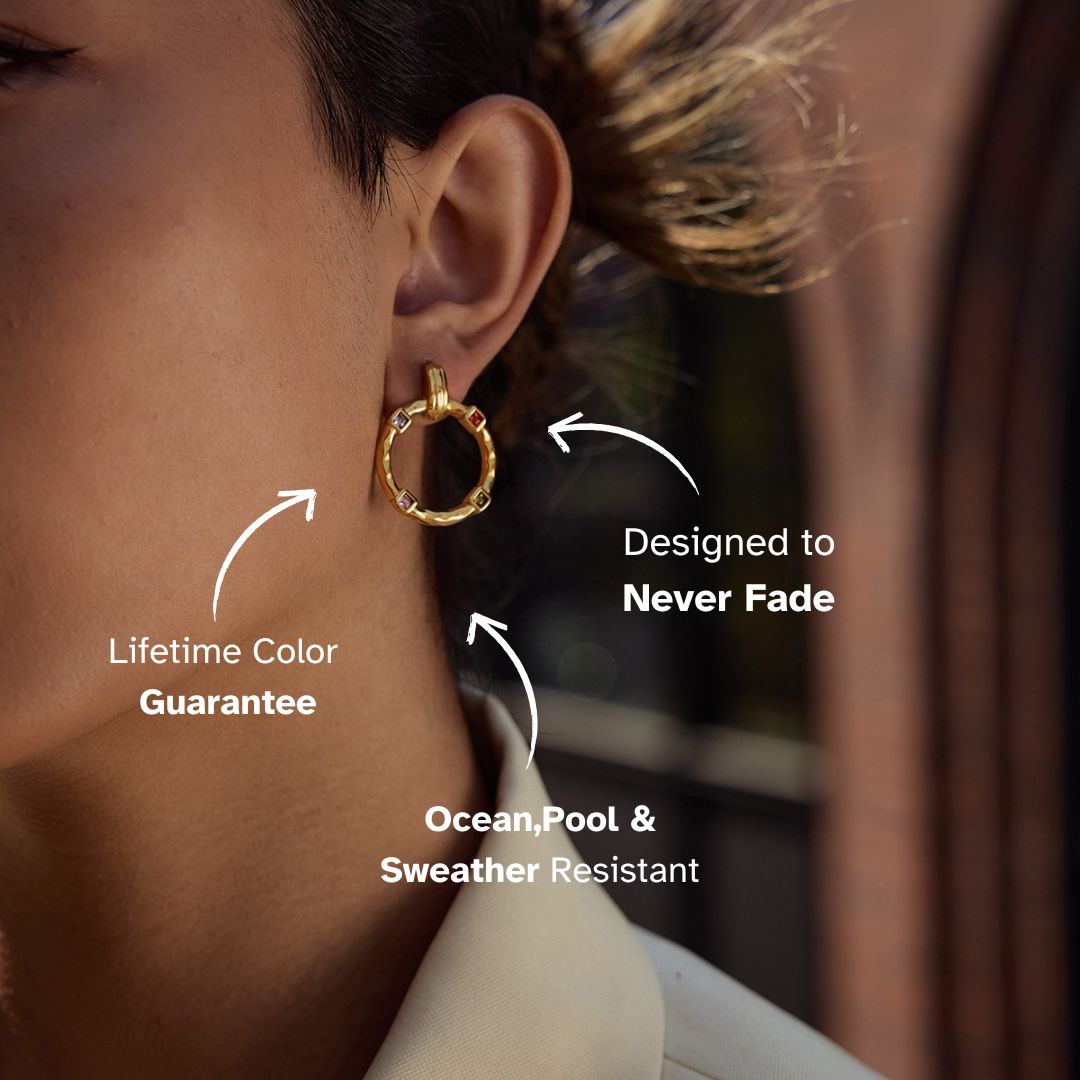 Close-up of gold hoop earrings with rainbow crystals on model, outdoor sunlight scene
