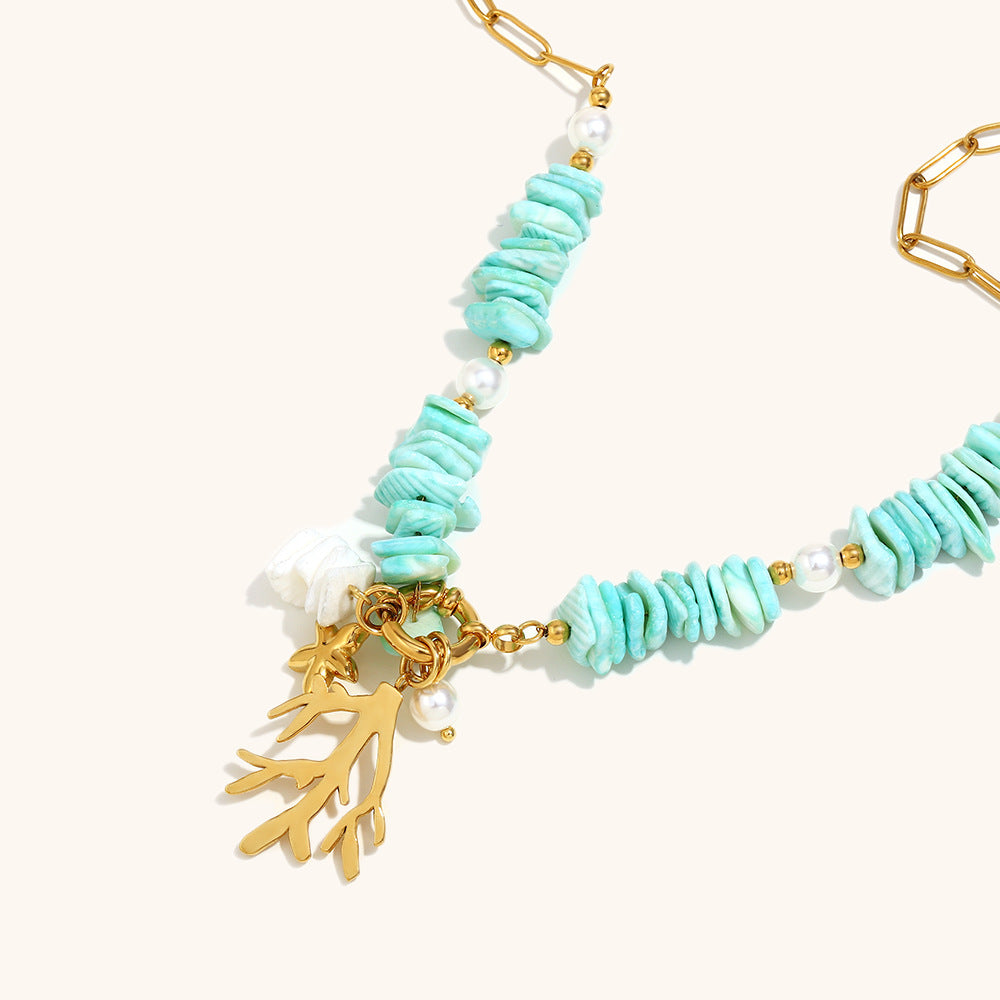 Turquoise and pearl beaded necklace with coral and seashell charms