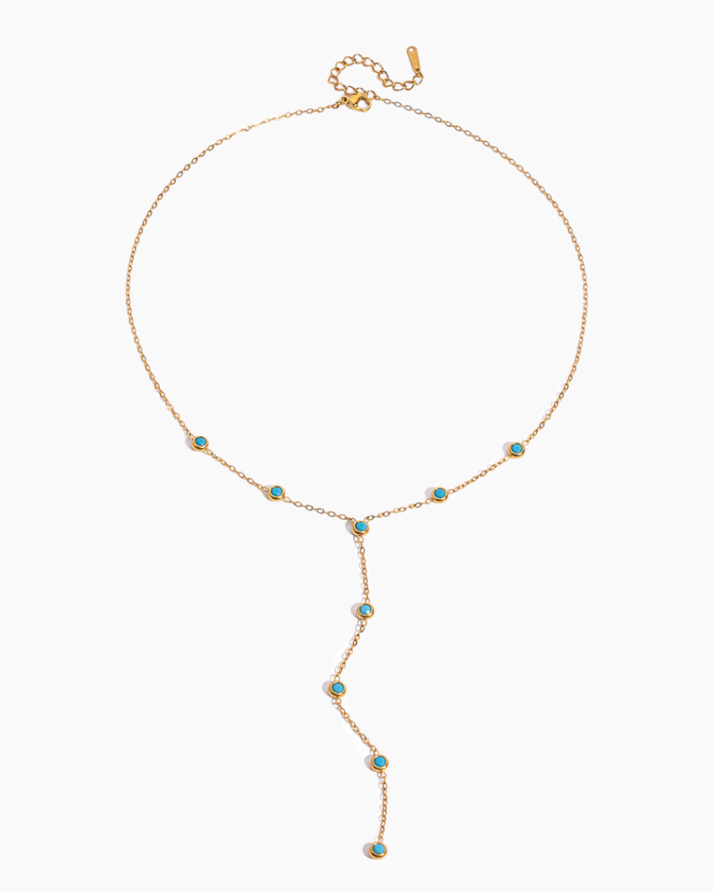 Gold necklace with turquoise stones on a white background