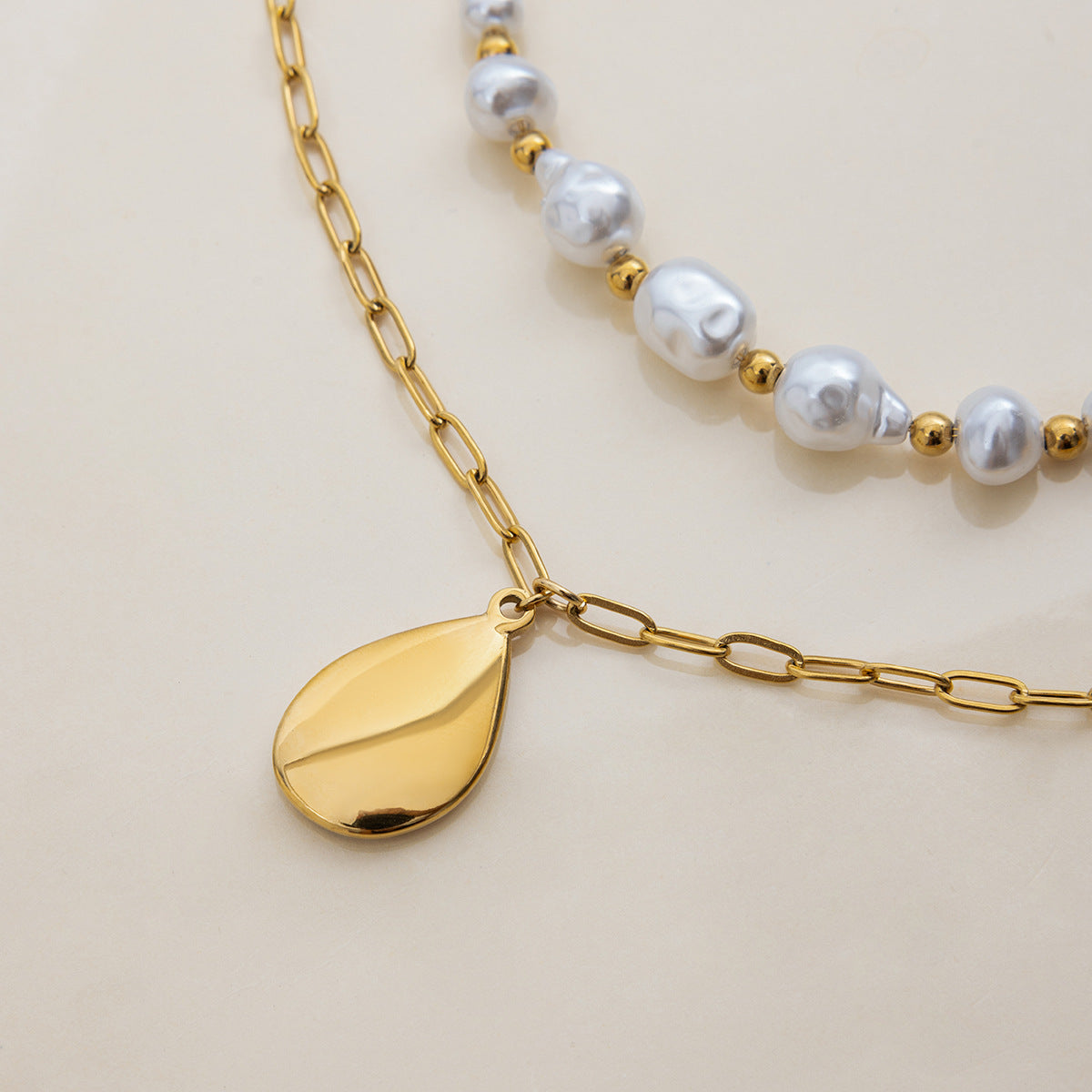 Double-layer necklace with baroque pearls and mushroom charm on model’s neck under sunlight