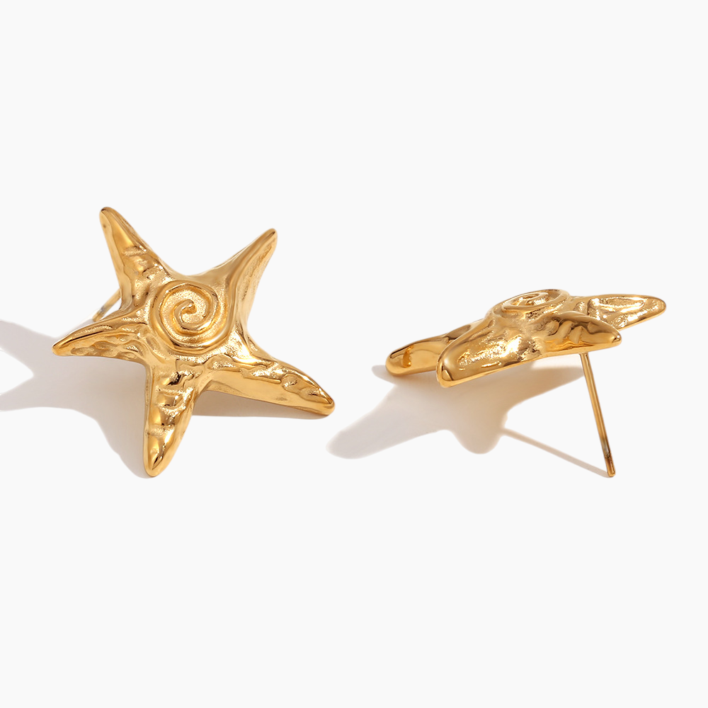 Gold star-shaped earrings on a white background