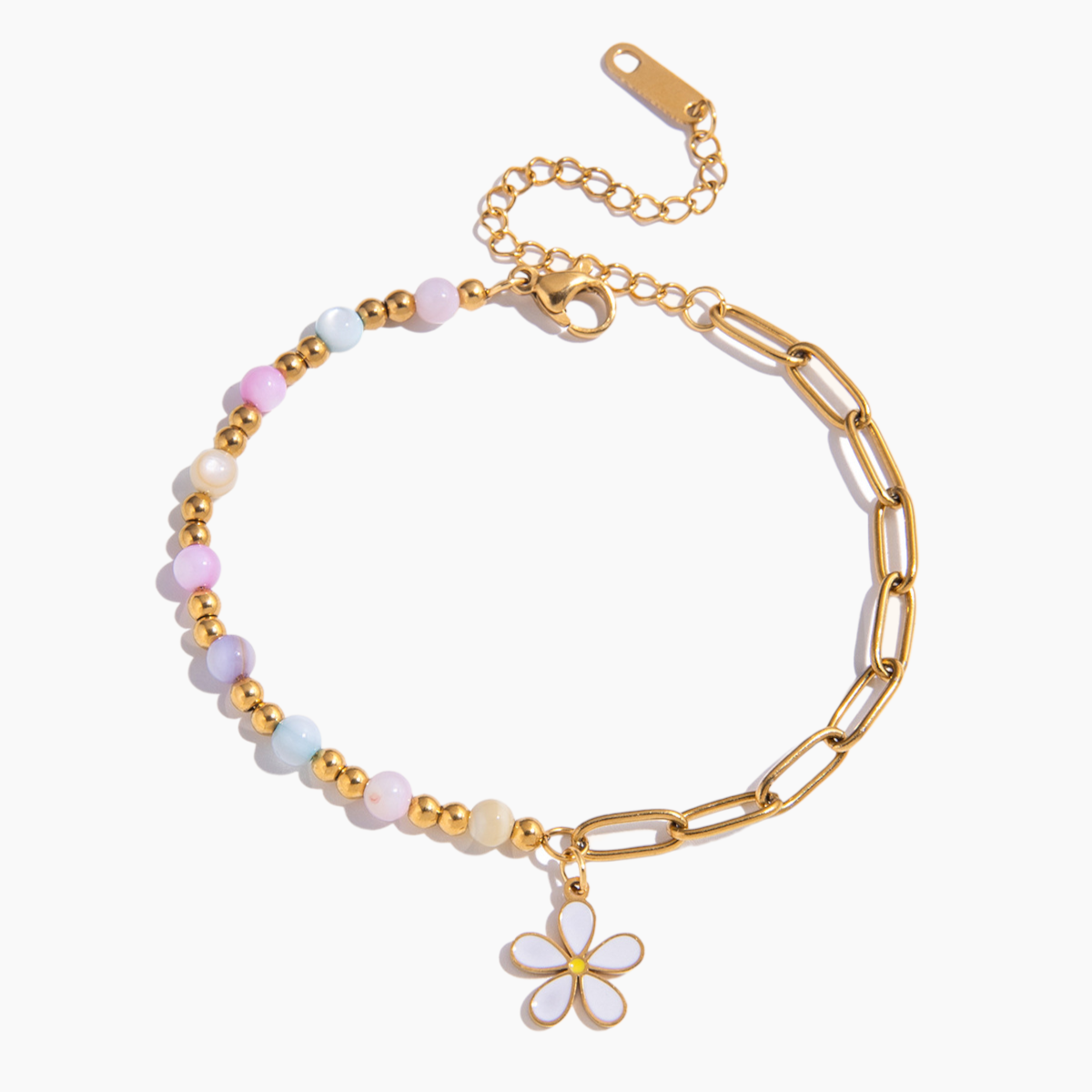 Bracelet with gold chain and flower charm on a white background