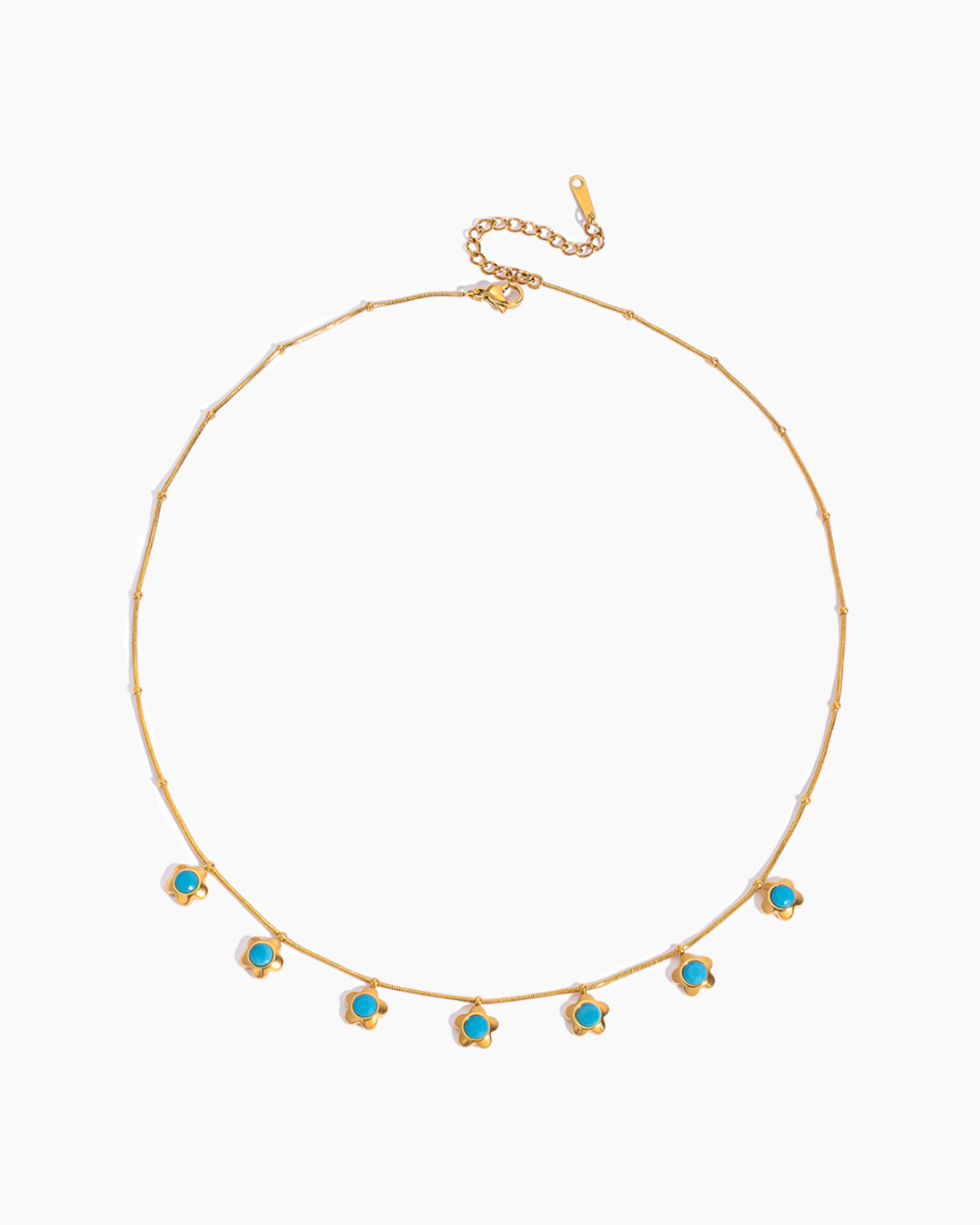 Gold necklace with turquoise stones on a white background
