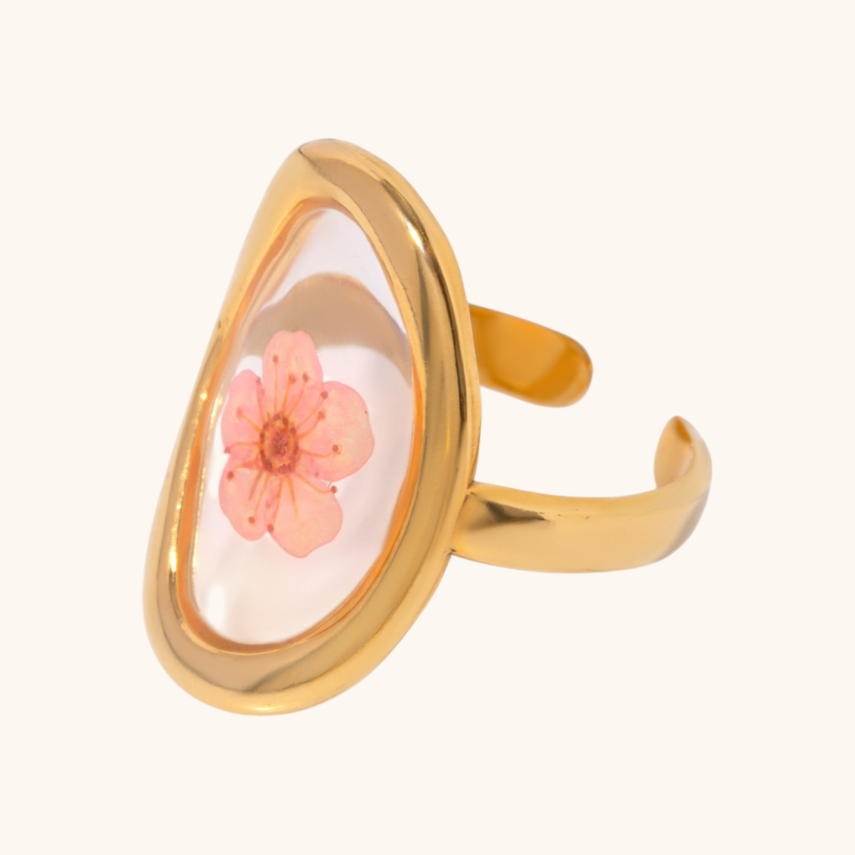 Pink cherry blossom flower preserved in a gold oval adjustable ring