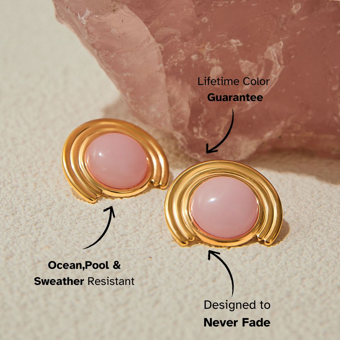 Pink cat eye stone earrings with gold-tone rounded edges near rose quartz
