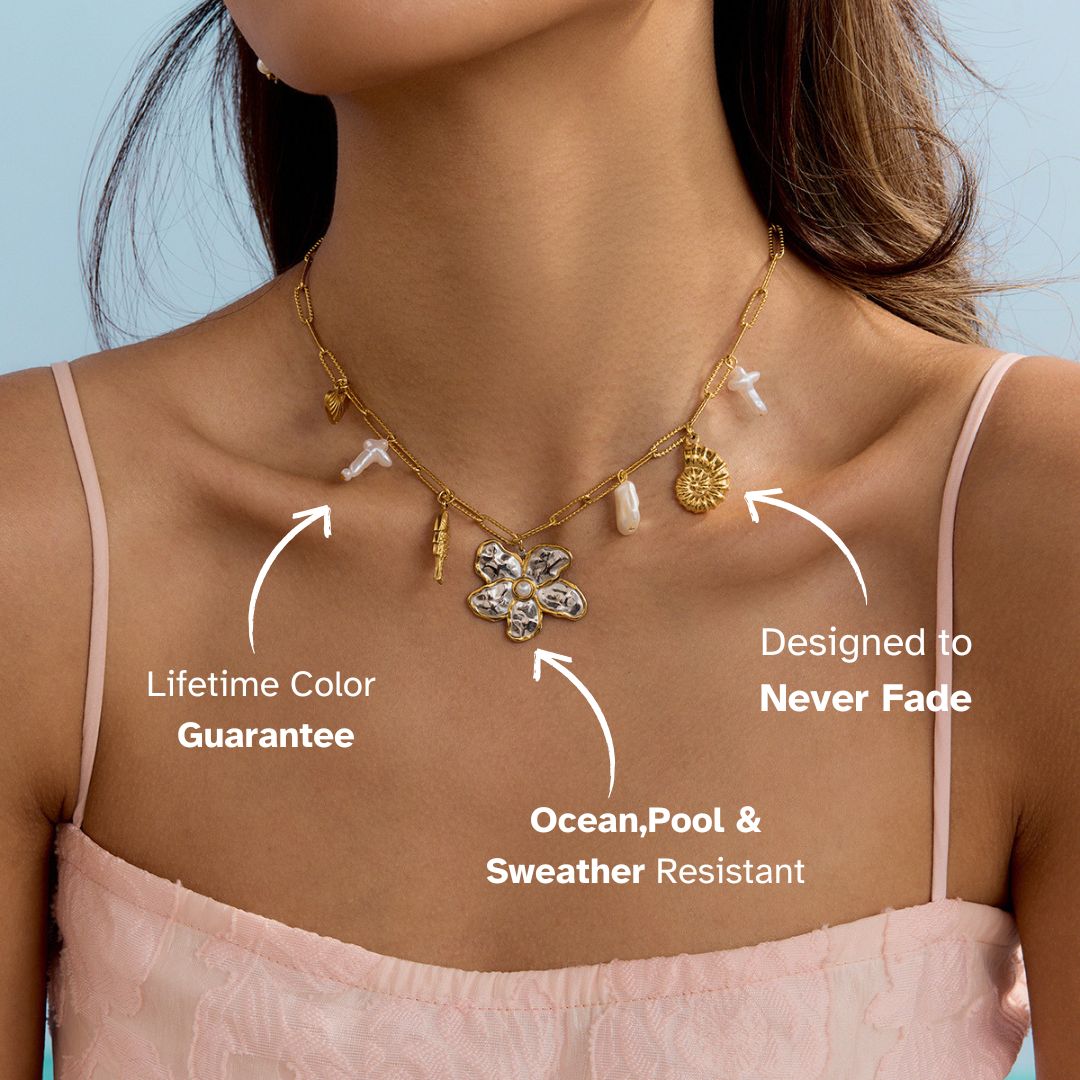 Woman in pink dress wearing layered gold necklace with pearl and mixed pendants – waterproof statement necklace for vacation