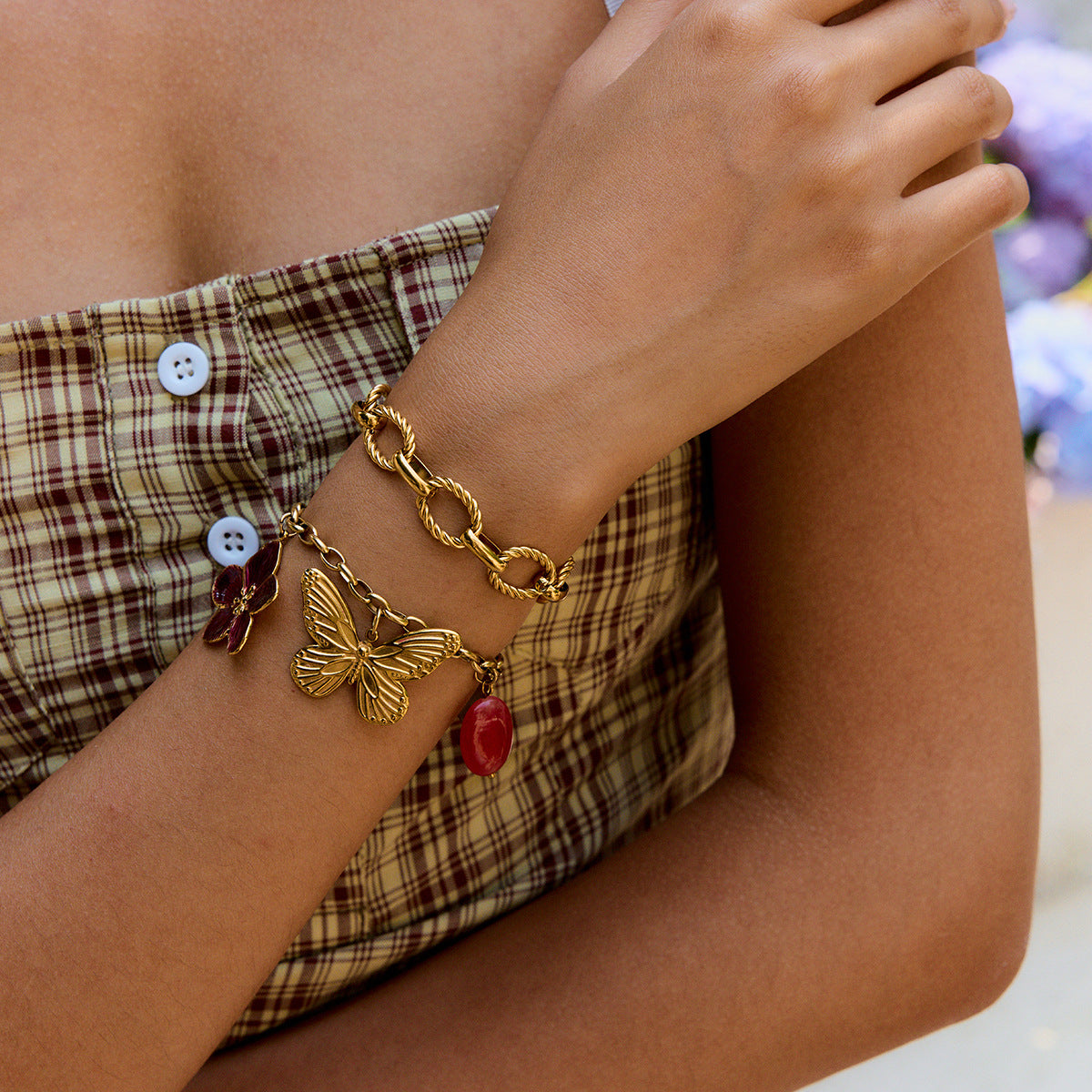 Bracelet styled with plaid dress, layered with twisted gold bangle