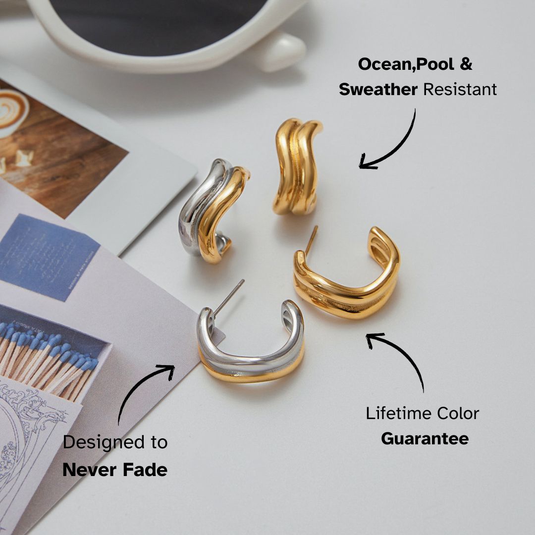 Close-up of thick gold hoop earrings with smooth wavy texture