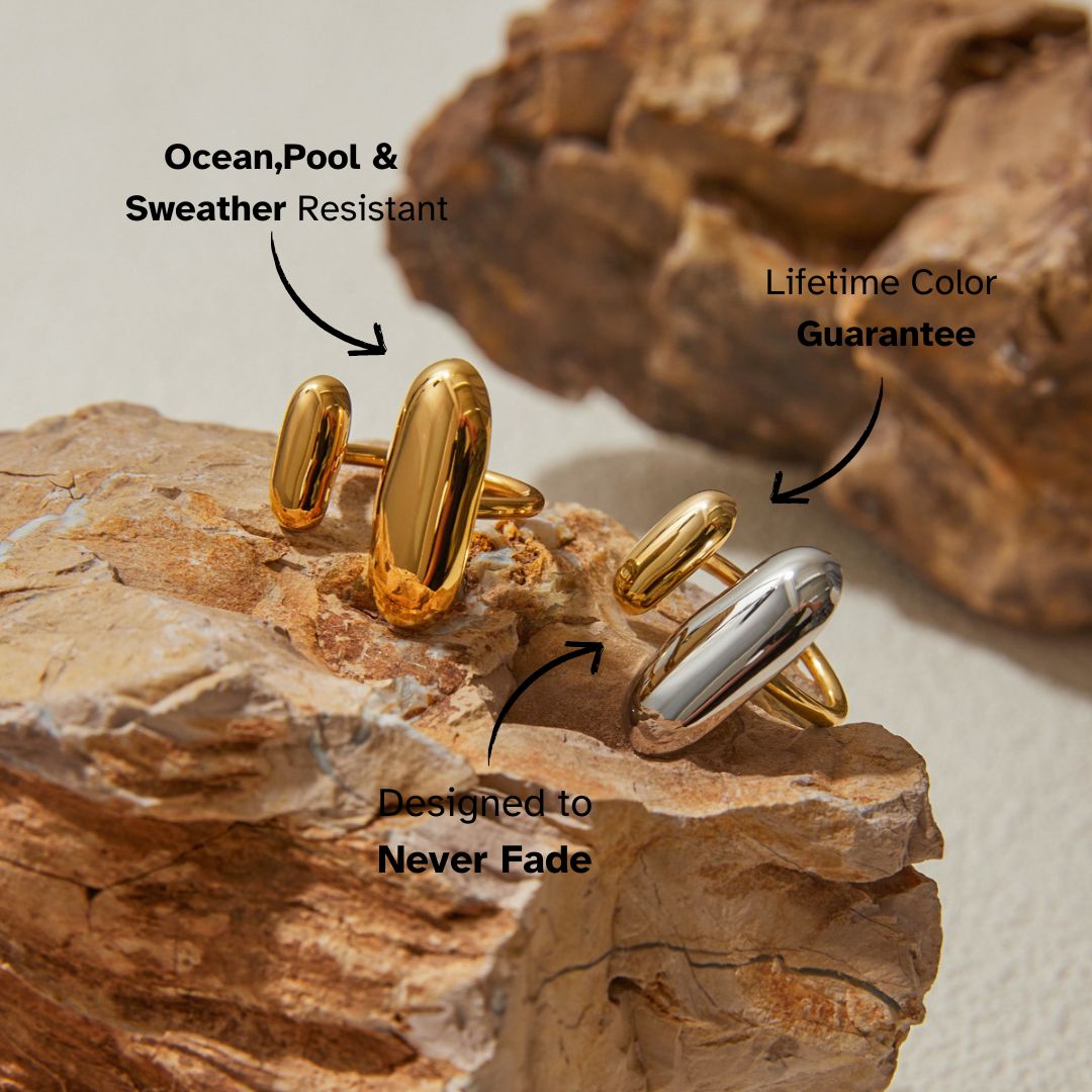 Close-up of gold chunky statement open ring on rock surface, ideal for modern minimal style