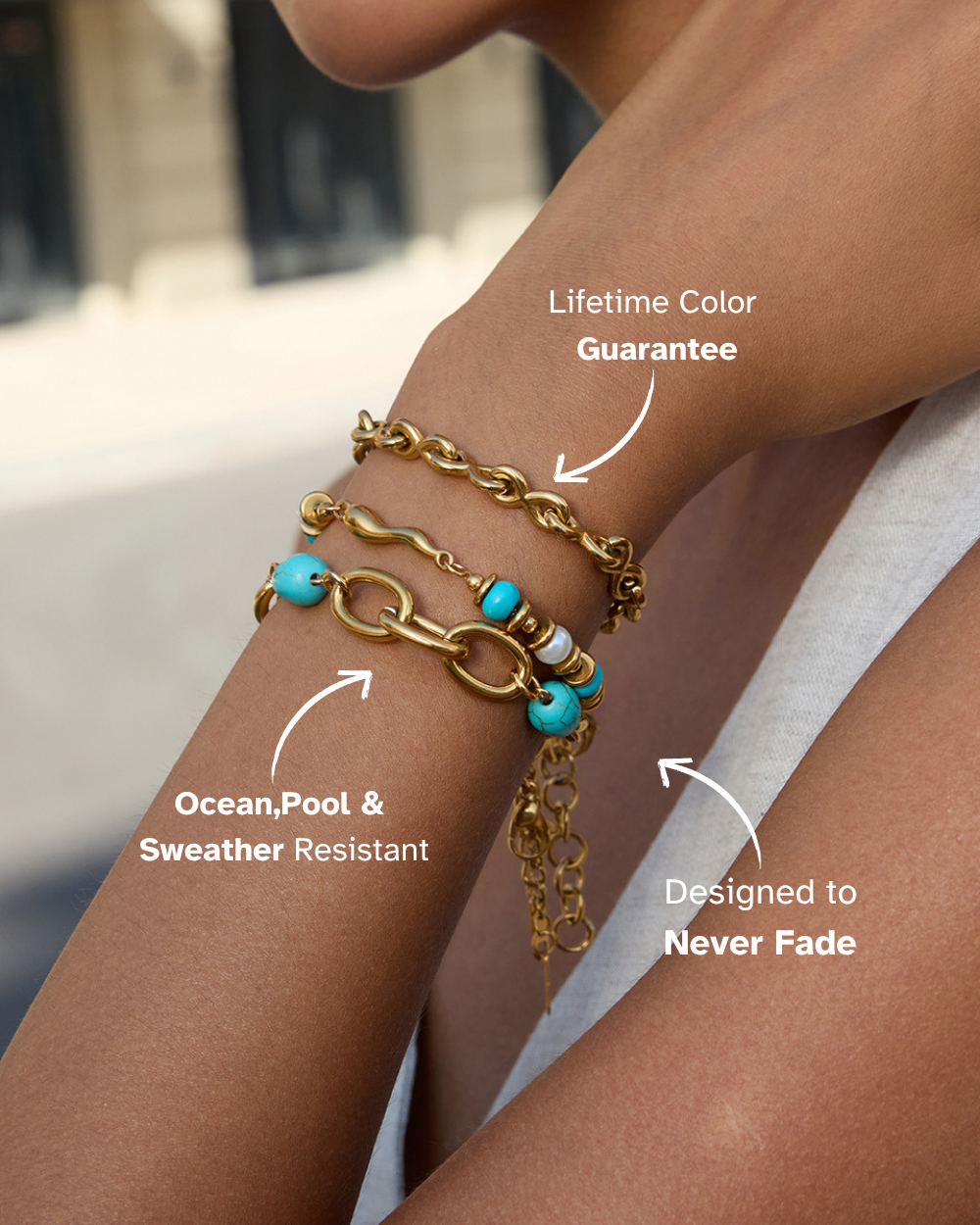 Gold chain bracelet with turquoise beads on a wrist, labeled for durability and color guarantee.