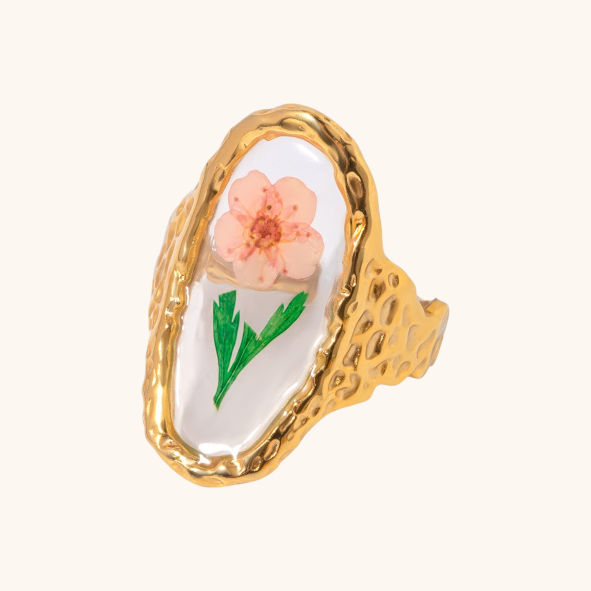 Organic textured gold ring with pink floral and green leaf preserved inside resin