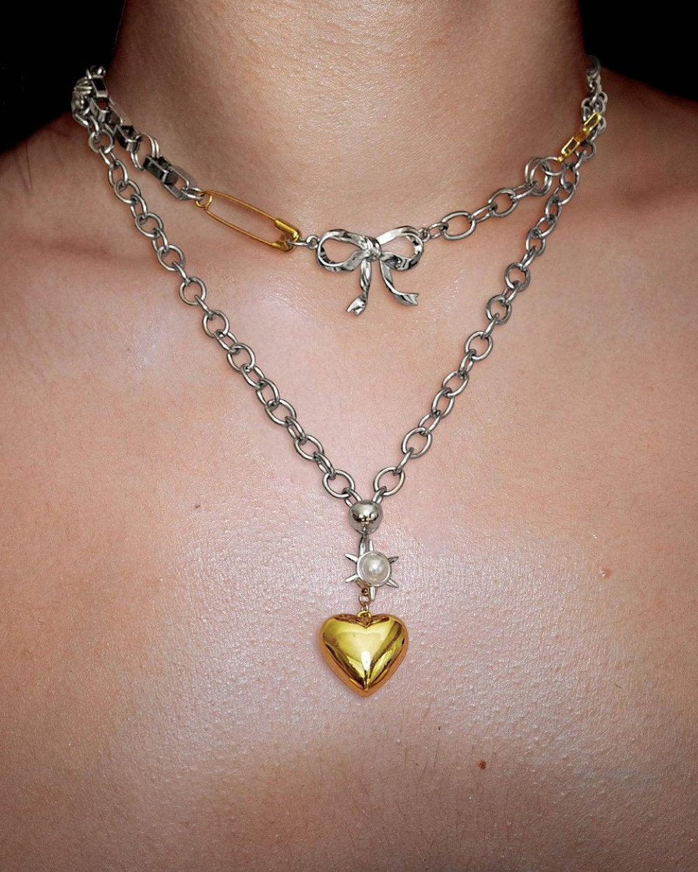 Necklace with a gold heart pendant and chain on a person's neck