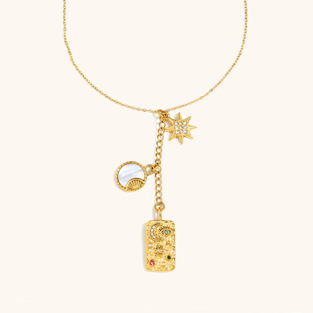 Dainty gold necklace with moon and star charms for celestial style lovers