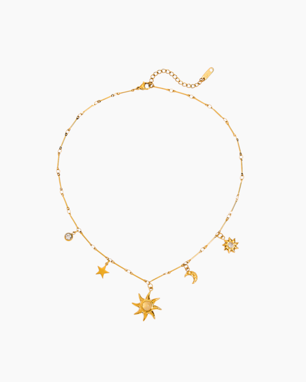 Gold necklace with star and moon charms on a white background