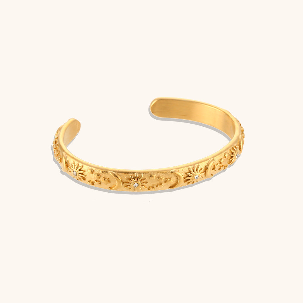 Close-up of celestial floral bracelet with vintage-style star engravings