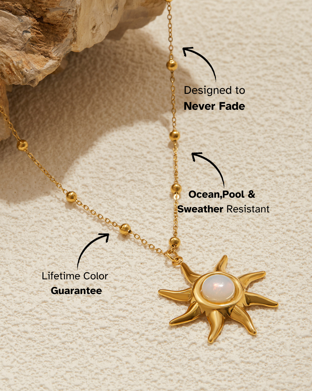 Gold necklace with sun pendant on a textured beige surface