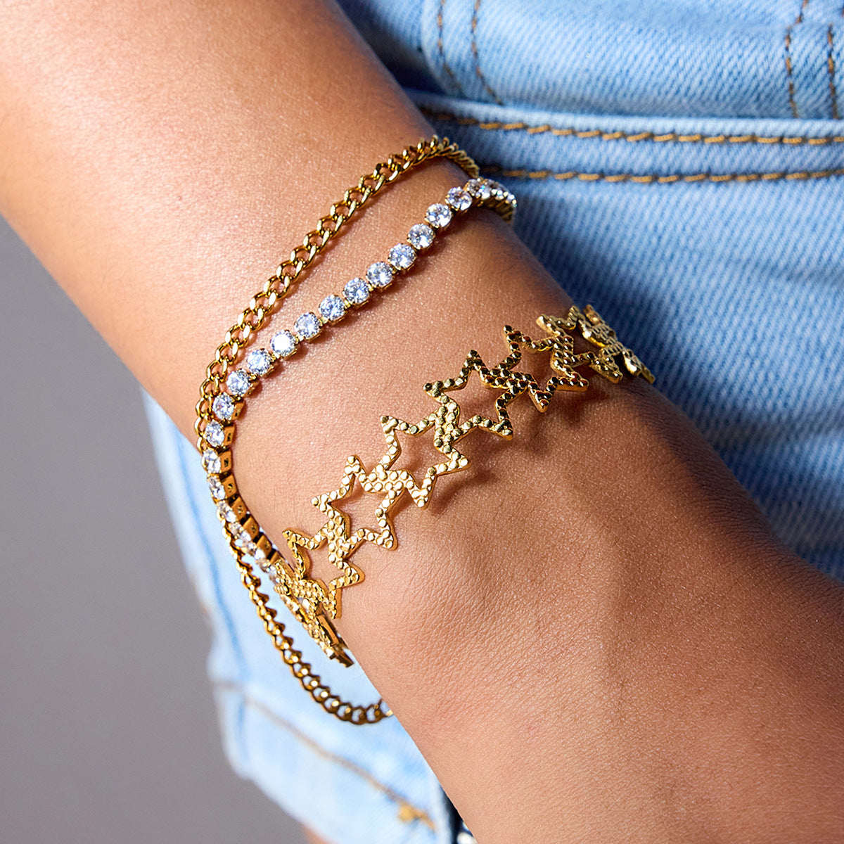 Layered bracelets with gold stars and crystals on wrist