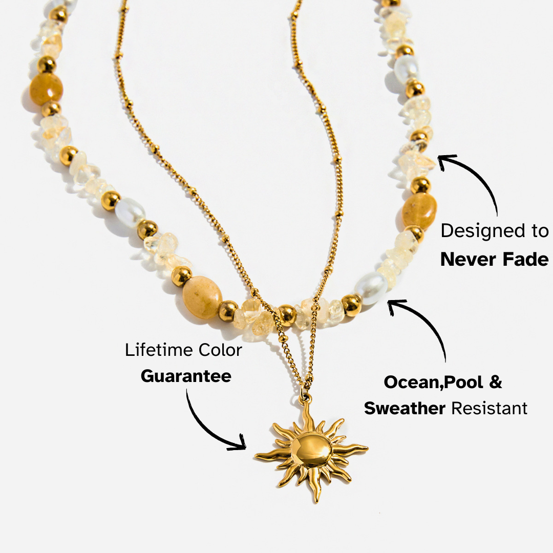 Two layered necklaces with sun pendant and bead details on a white background