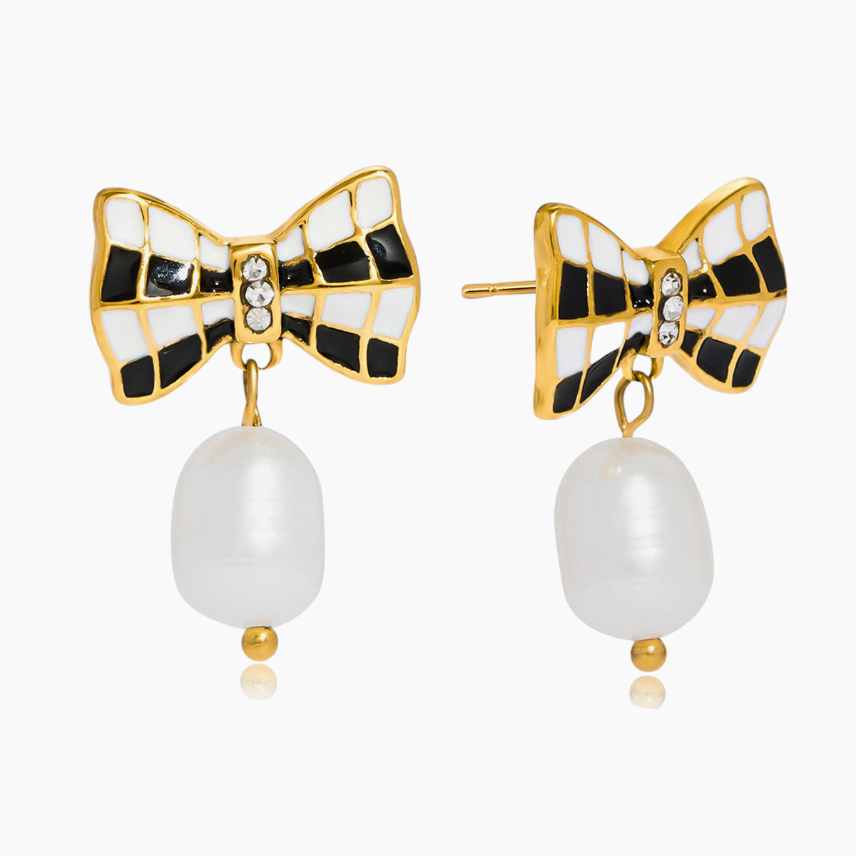 Bow-shaped earrings with pearl drops on a white background