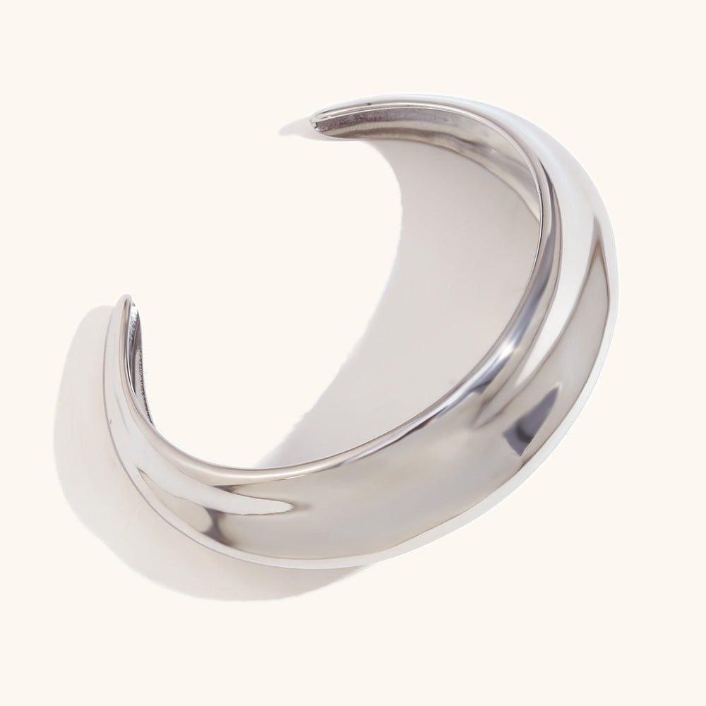 Minimalist outfit elevated with bold dome cuff on bare forearm