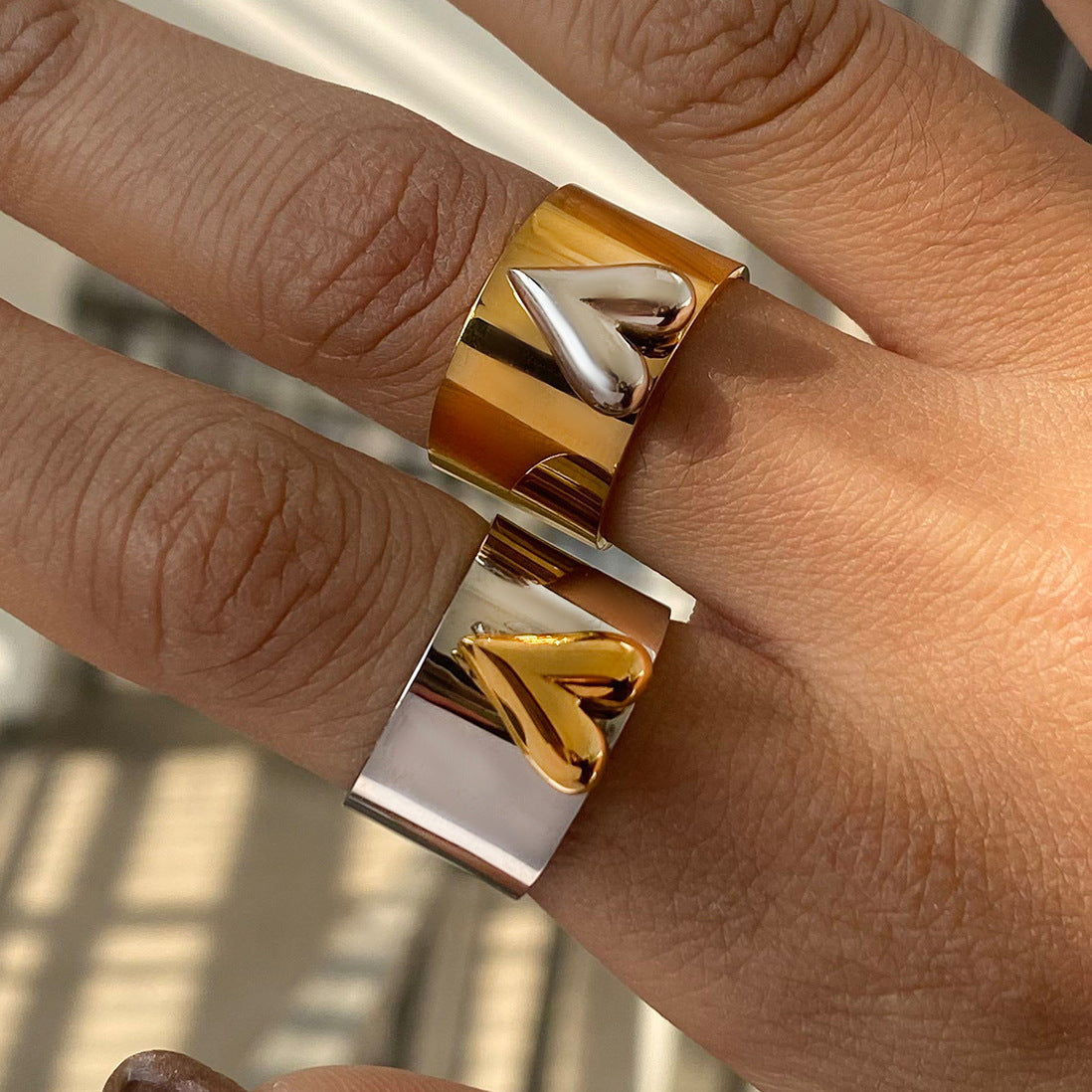 Modern bold love ring for women, photographed on stone surface