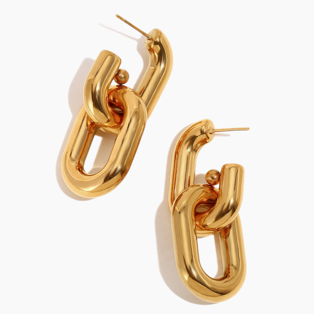 Statement link earrings paired with minimalist necklace for layered look