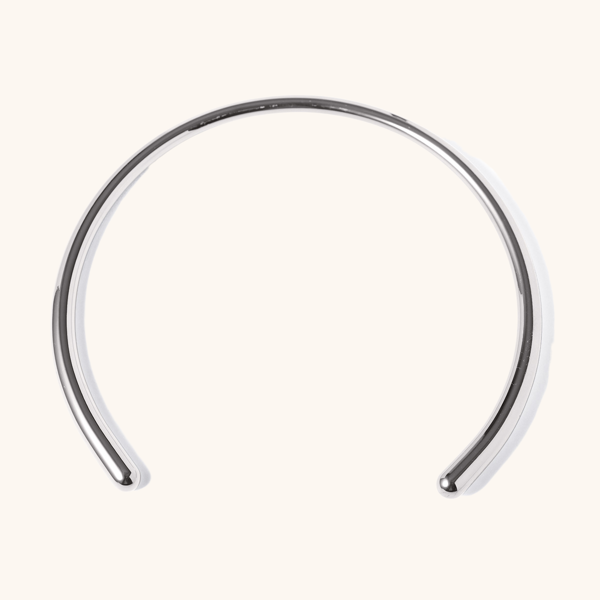 Thick gold and silver collar necklaces displayed on satin background