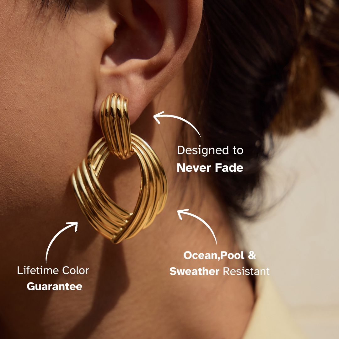 Chunky interloop gold earrings highlighting curved layered design on model’s ear
