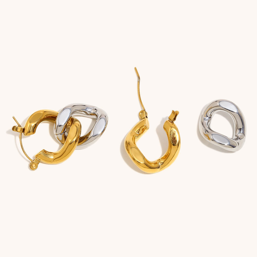 Gold and silver two-tone chunky drop earrings with detachable links on white background