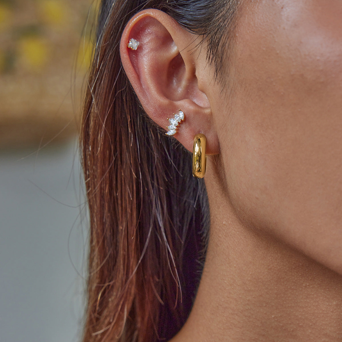 Minimalist gold hoops styled with crystal studs